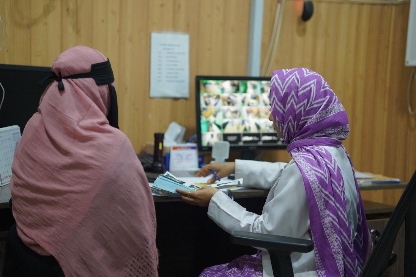 Bushra, a doctor, with a patient at the clinic in Karachi