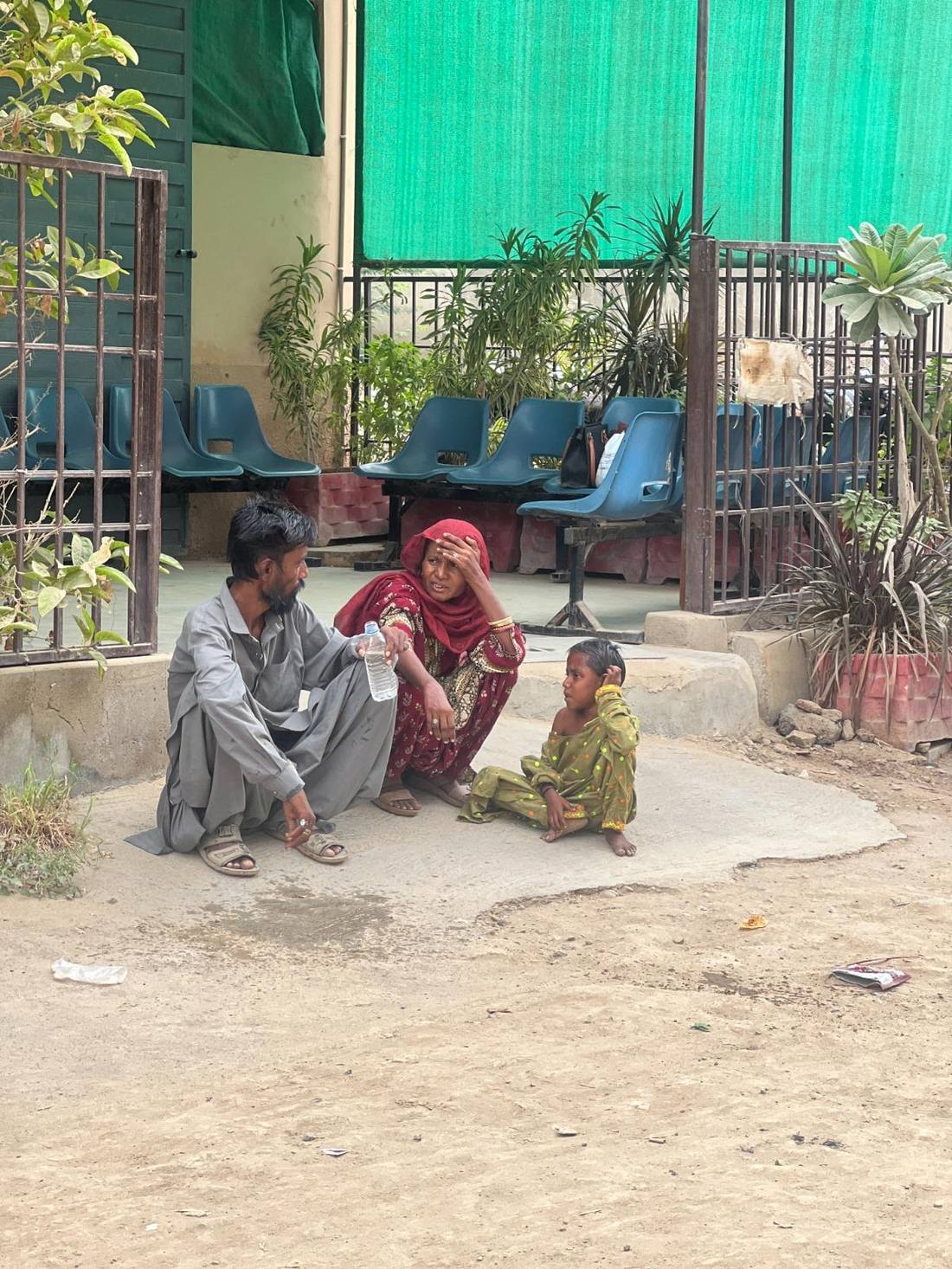 A family waits to be seen outside a clinic in Karachi